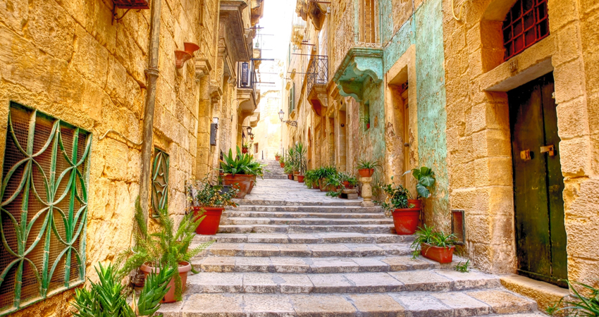 a narrow city street in the city of Valetta